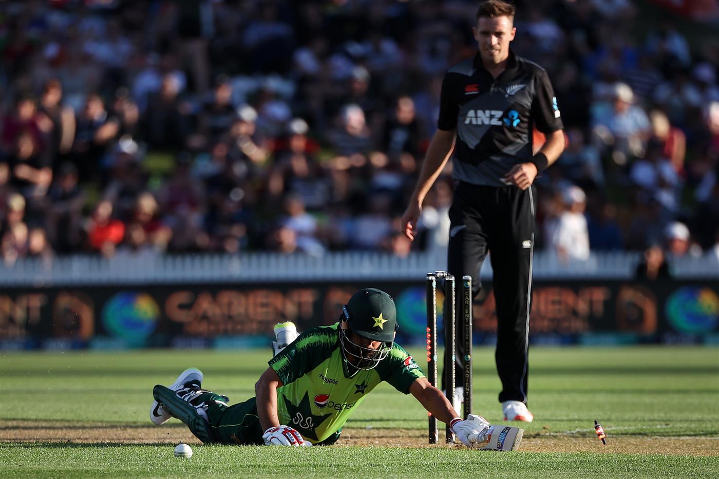 HAMILTON, NEW ZEALAND - DECEMBER 20: Mohammad Hafeez of Pakistan slides into the crease with Tim Southee of New Zealand 
 (R) during game two of the International T20 series between New Zealand and Pakistan at Seddon Park on December 20, 2020 in Hamilton, New Zealand. (Photo by Fiona Goodall/Getty Images)