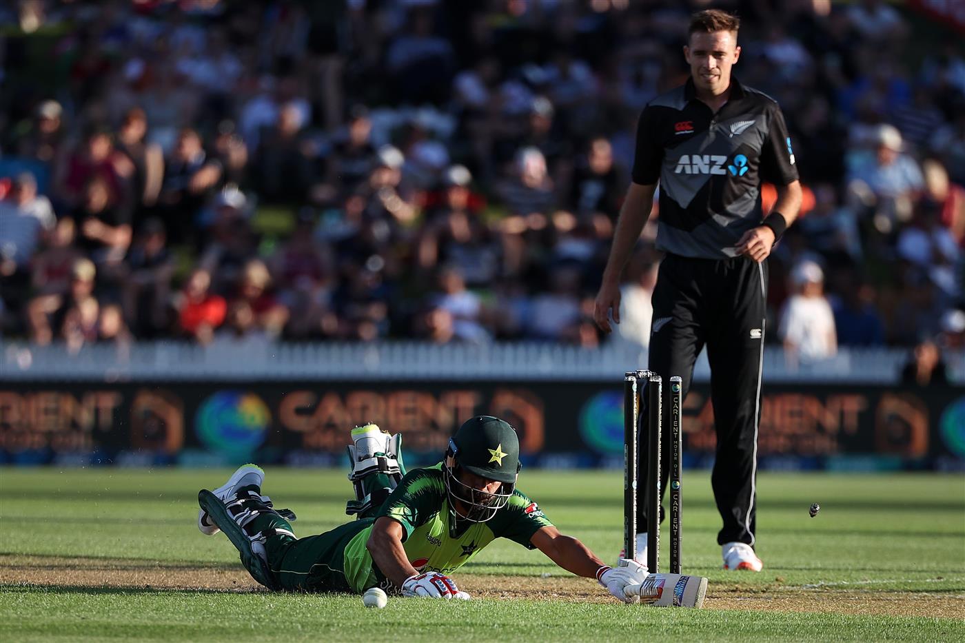 HAMILTON, NEW ZEALAND - DECEMBER 20: Mohammad Hafeez of Pakistan slides into the crease with Tim Southee of New Zealand 
 (R) during game two of the International T20 series between New Zealand and Pakistan at Seddon Park on December 20, 2020 in Hamilton, New Zealand. (Photo by Fiona Goodall/Getty Images)