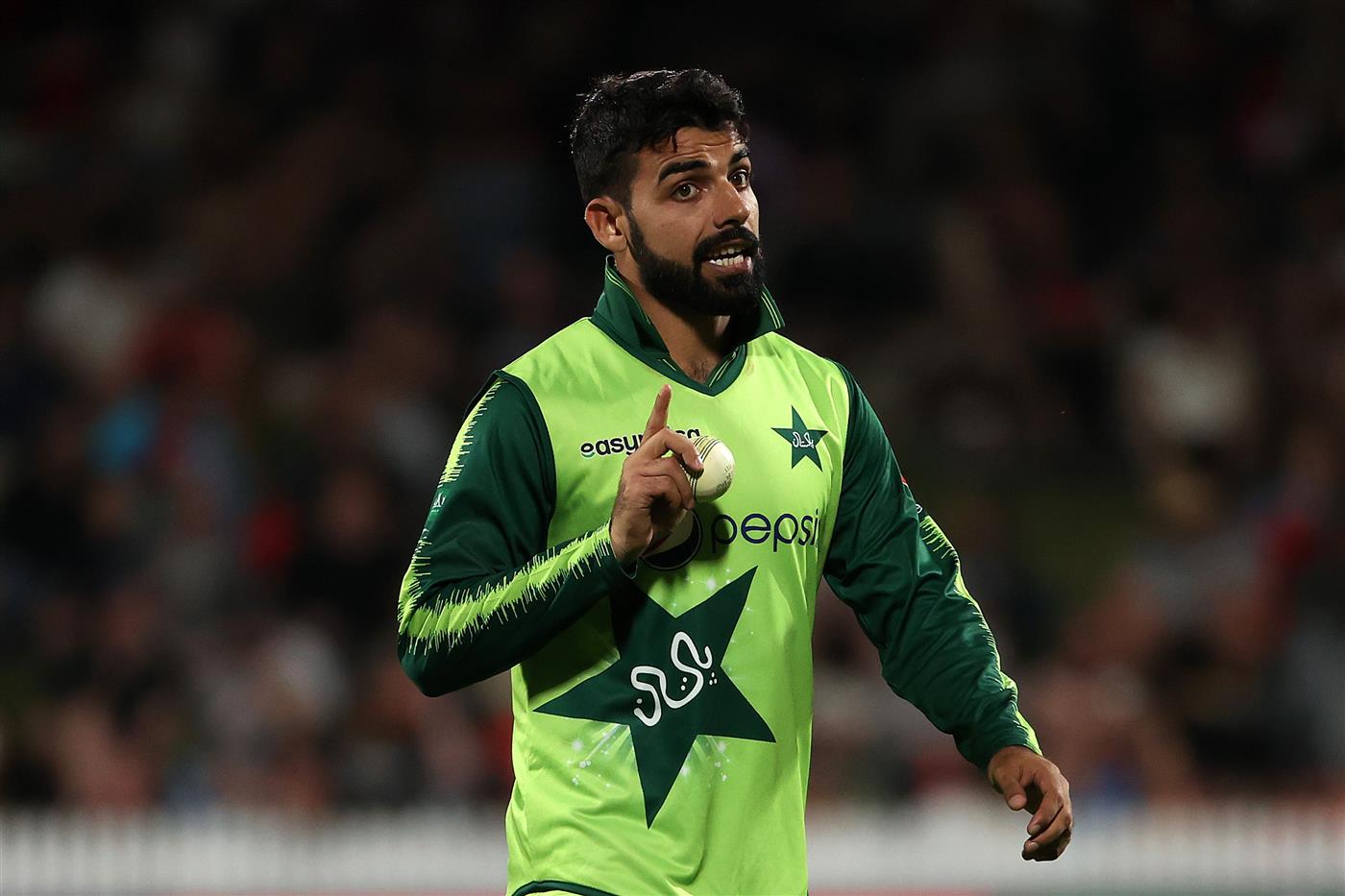 HAMILTON, NEW ZEALAND - DECEMBER 20: Shadab Khan captain of Pakistan motivates Faheem Ashraf of Pakistan
 for the last over during game two of the International T20 series between New Zealand and Pakistan at Seddon Park on December 20, 2020 in Hamilton, New Zealand. (Photo by Fiona Goodall/Getty Images)