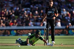 HAMILTON, NEW ZEALAND - DECEMBER 20: Mohammad Hafeez of Pakistan slides into the crease with Tim Southee of New Zealand 
 (R) during game two of the International T20 series between New Zealand and Pakistan at Seddon Park on December 20, 2020 in Hamilton, New Zealand. (Photo by Fiona Goodall/Getty Images)