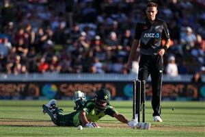 HAMILTON, NEW ZEALAND - DECEMBER 20: Mohammad Hafeez of Pakistan slides into the crease with Tim Southee of New Zealand 
 (R) during game two of the International T20 series between New Zealand and Pakistan at Seddon Park on December 20, 2020 in Hamilton, New Zealand. (Photo by Fiona Goodall/Getty Images)