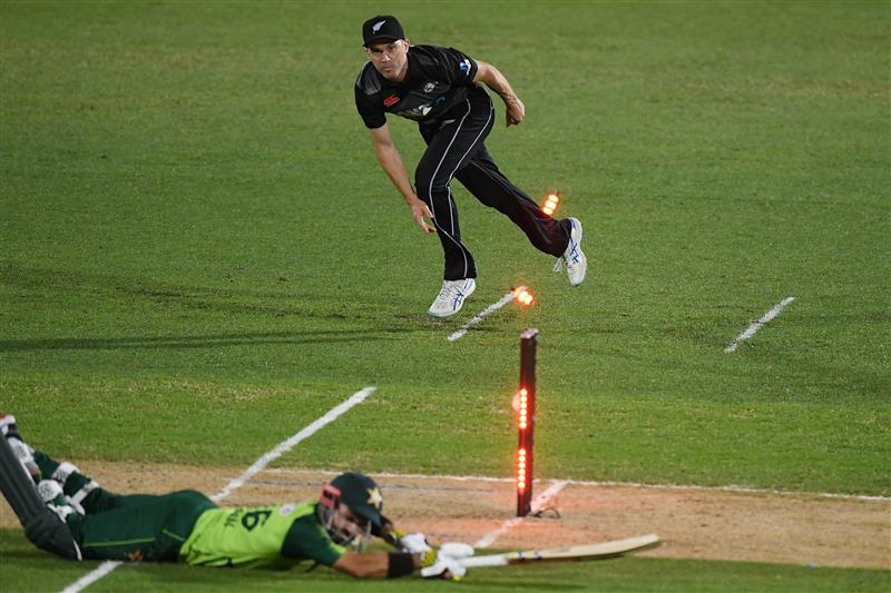 NAPIER, NEW ZEALAND - DECEMBER 22: Todd Astle of New Zealand attempts to runout Mohammad Rizwan of Pakistan during the third game of the International T20 series between New Zealand and Pakistan at McLean Park on December 22, 2020 in Napier, New Zealand. (Photo by Kerry Marshall/Getty Images)
