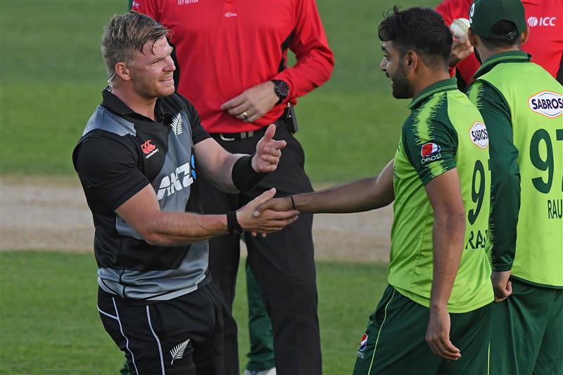NAPIER, NEW ZEALAND - DECEMBER 22: Glenn Phillips of New Zealand and Haris Rauf of Pakistan joke as sunstrike stops play during the third game of the International T20 series between New Zealand and Pakistan at McLean Park on December 22, 2020 in Napier, New Zealand. (Photo by Kerry Marshall/Getty Images)
