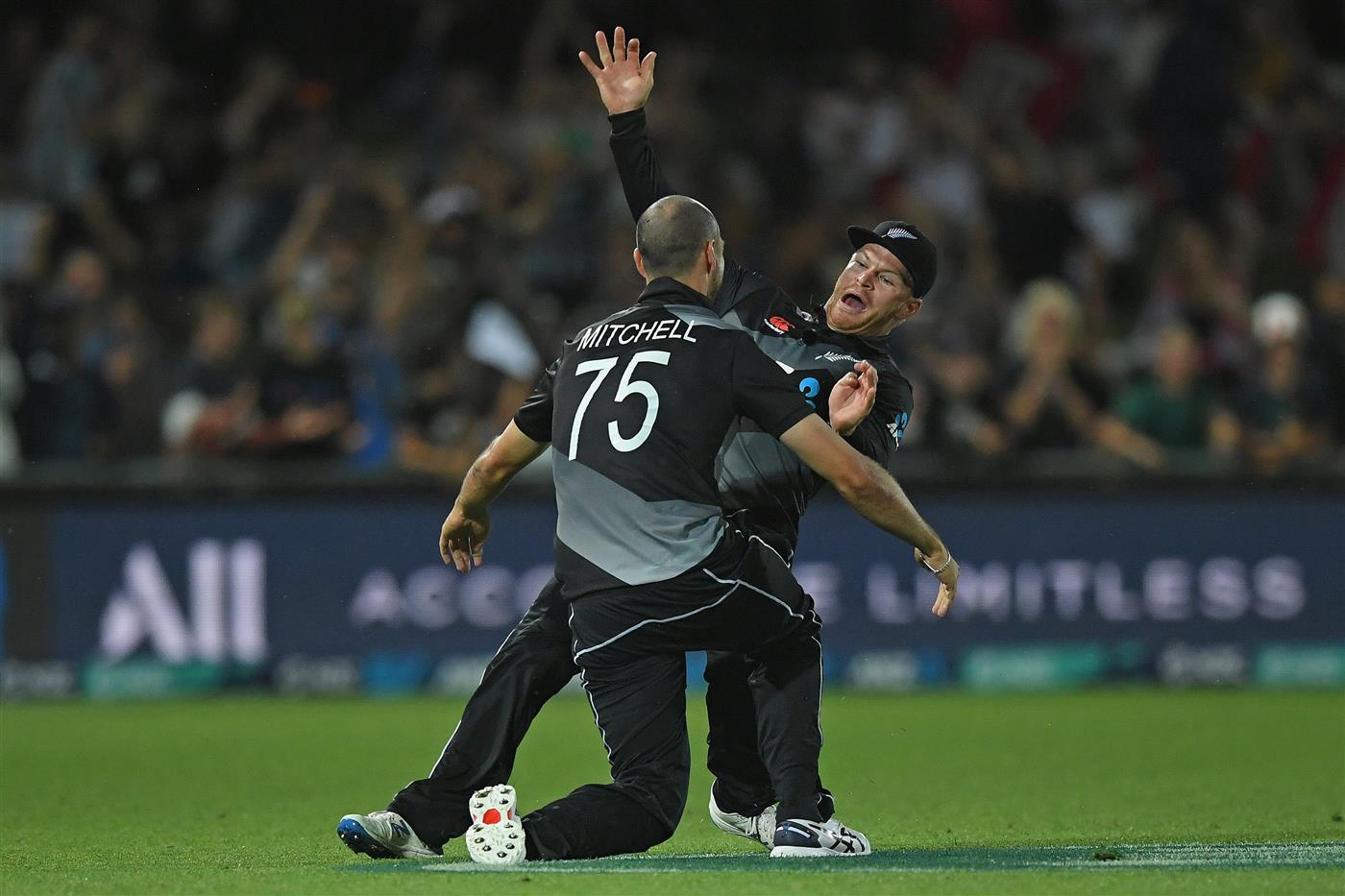 NAPIER, NEW ZEALAND - DECEMBER 22: Daryl Mitchell and Glenn Phillips of New Zealand celebrate a wicket during the third game of the International T20 series between New Zealand and Pakistan at McLean Park on December 22, 2020 in Napier, New Zealand. (Photo by Kerry Marshall/Getty Images)