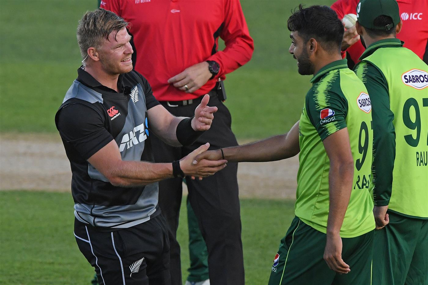 NAPIER, NEW ZEALAND - DECEMBER 22: Glenn Phillips of New Zealand and Haris Rauf of Pakistan joke as sunstrike stops play during the third game of the International T20 series between New Zealand and Pakistan at McLean Park on December 22, 2020 in Napier, New Zealand. (Photo by Kerry Marshall/Getty Images)