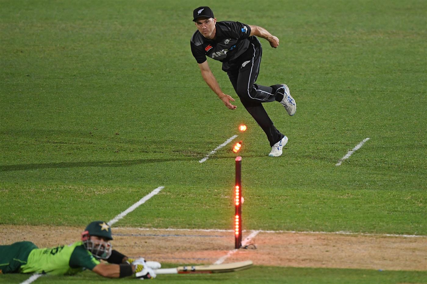 NAPIER, NEW ZEALAND - DECEMBER 22: Todd Astle of New Zealand attempts to runout Mohammad Rizwan of Pakistan during the third game of the International T20 series between New Zealand and Pakistan at McLean Park on December 22, 2020 in Napier, New Zealand. (Photo by Kerry Marshall/Getty Images)