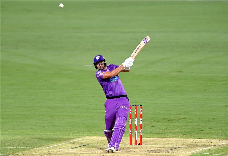 BRISBANE, AUSTRALIA - DECEMBER 30: Tim David of the Hurricanes hits the ball to the boundary for a four during the Big Bash League match between the Hobart Hurricanes and Brisbane Heat at The Gabba, on December 30, 2020, in Brisbane, Australia. (Photo by Bradley Kanaris/Getty Images)