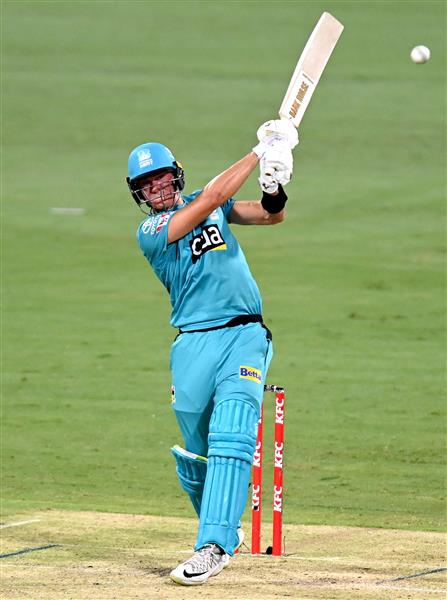 BRISBANE, AUSTRALIA - DECEMBER 30: James Bazley of the Heat hits the ball to the boundary for a four during the Big Bash League match between the Hobart Hurricanes and Brisbane Heat at The Gabba, on December 30, 2020, in Brisbane, Australia. (Photo by Bradley Kanaris/Getty Images)