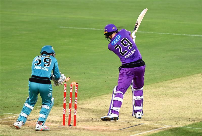 BRISBANE, AUSTRALIA - DECEMBER 30: Dawid Malan of the Hurricanes is bowled out by Mujeeb Ur Rahman of the Heat during the Big Bash League match between the Hobart Hurricanes and Brisbane Heat at The Gabba, on December 30, 2020, in Brisbane, Australia. (Photo by Bradley Kanaris/Getty Images)