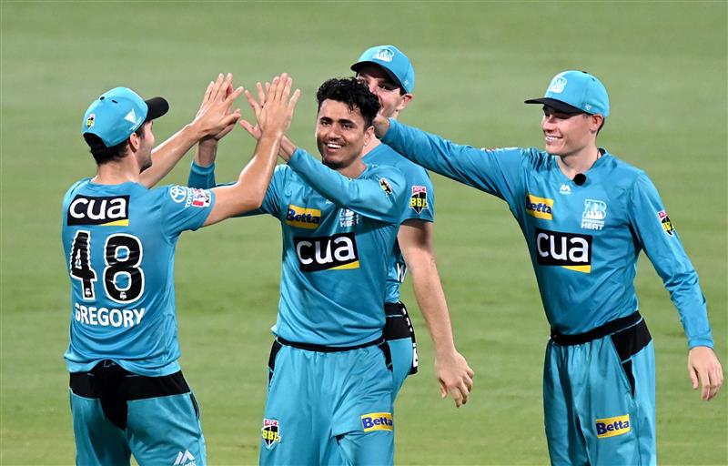 BRISBANE, AUSTRALIA - DECEMBER 30: Mujeeb Ur Rahman of the Heat celebrates taking the wicket of Wil Parker of the Hurricanes during the Big Bash League match between the Hobart Hurricanes and Brisbane Heat at The Gabba, on December 30, 2020, in Brisbane, Australia. (Photo by Bradley Kanaris/Getty Images)