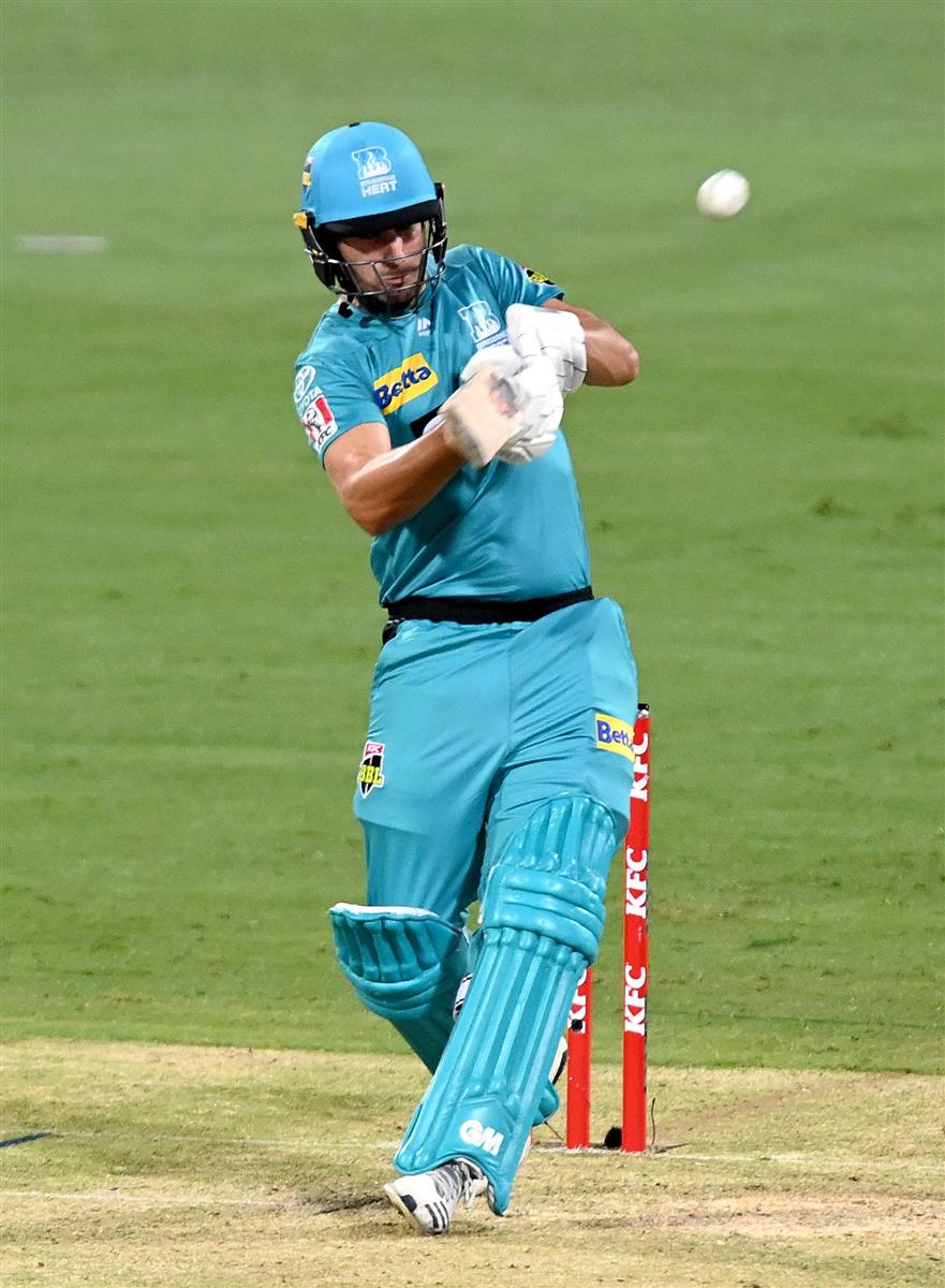 BRISBANE, AUSTRALIA - DECEMBER 30: Lewis Gregory of the Heat hits the ball to the boundary for a four during the Big Bash League match between the Hobart Hurricanes and Brisbane Heat at The Gabba, on December 30, 2020, in Brisbane, Australia. (Photo by Bradley Kanaris/Getty Images)