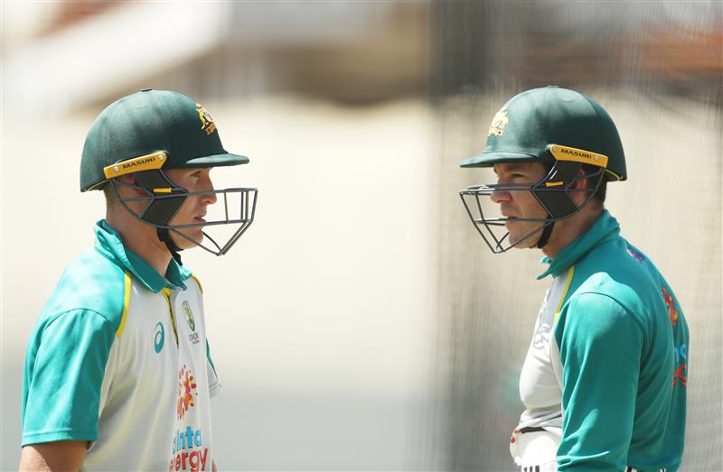 SYDNEY, AUSTRALIA - JANUARY 05: Tim Paine of Australia talks to Marnus Labuschagne of Australia during an Australian nets session at the Sydney Cricket Ground on January 05, 2021 in Sydney, Australia. (Photo by Mark Metcalfe/Getty Images)