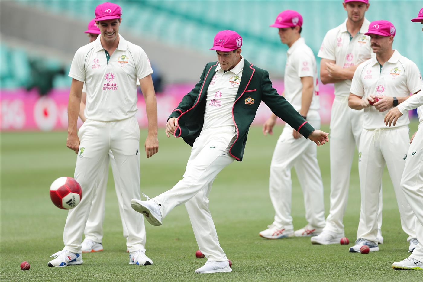 SYDNEY, AUSTRALIA - JANUARY 05: Tim Paine of Australia kicks a football during a Australian team photo during an Australian nets session at the Sydney Cricket Ground on January 05, 2021 in Sydney, Australia. (Photo by Mark Metcalfe/Getty Images)