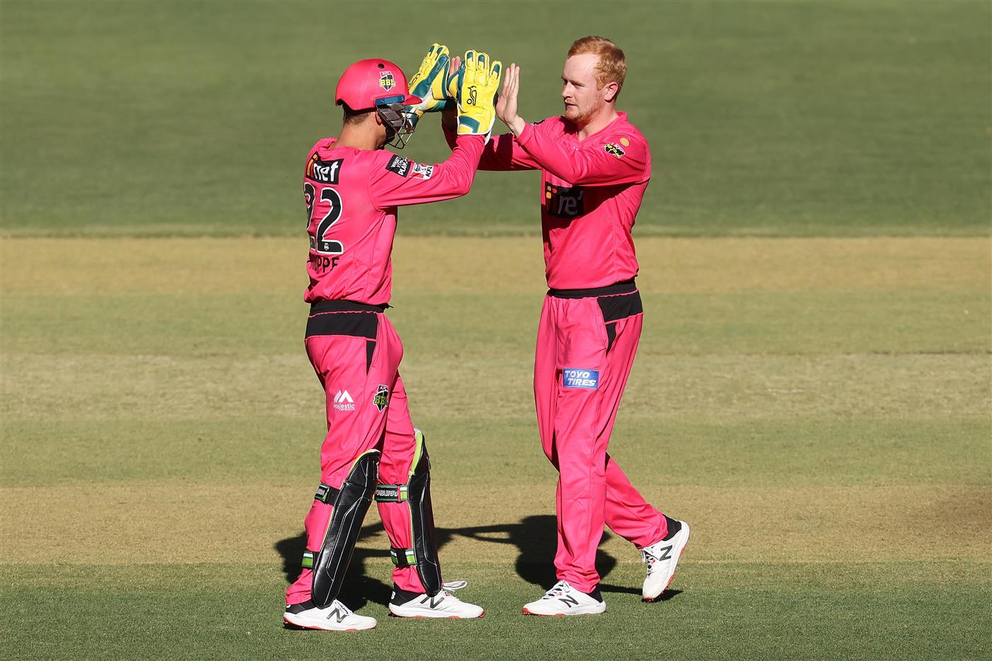 PERTH, AUSTRALIA - JANUARY 06: Josh Philippe and Lloyd Pope of the Sixers celebrate the wicket of Colin Munro of the Scorchers of the Scorchers during the Big Bash League match between the Perth Scorchers and the Sydney Sixers at Optus Stadium, on January 06, 2021, in Perth, Australia. (Photo by Paul Kane/Getty Images)