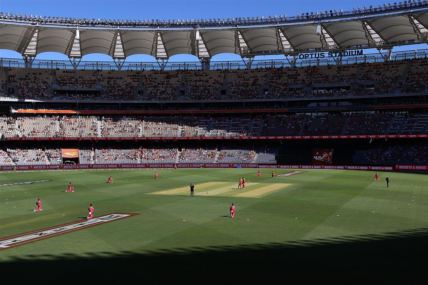 PERTH, AUSTRALIA - JANUARY 06: Sixers players take a knee for the BLM protest as Liam Livingstone and Jason Roy of the Scorchers stand during the Big Bash League match between the Perth Scorchers and the Sydney Sixers at Optus Stadium, on January 06, 2021, in Perth, Australia. (Photo by Paul Kane/Getty Images)