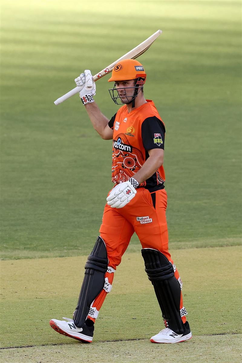 PERTH, AUSTRALIA - JANUARY 06: Mitch Marsh of the Scorchers raises his bat after reaching his half century during the Big Bash League match between the Perth Scorchers and the Sydney Sixers at Optus Stadium, on January 06, 2021, in Perth, Australia. (Photo by Paul Kane/Getty Images)