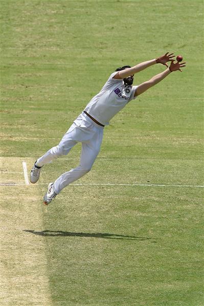 BRISBANE, AUSTRALIA - JANUARY 18: Mohammed Siraj of India fields off his own bowling during day four of the 4th Test Match in the series between Australia and India at The Gabba on January 18, 2021 in Brisbane, Australia. (Photo by Matt Roberts/Getty Images)