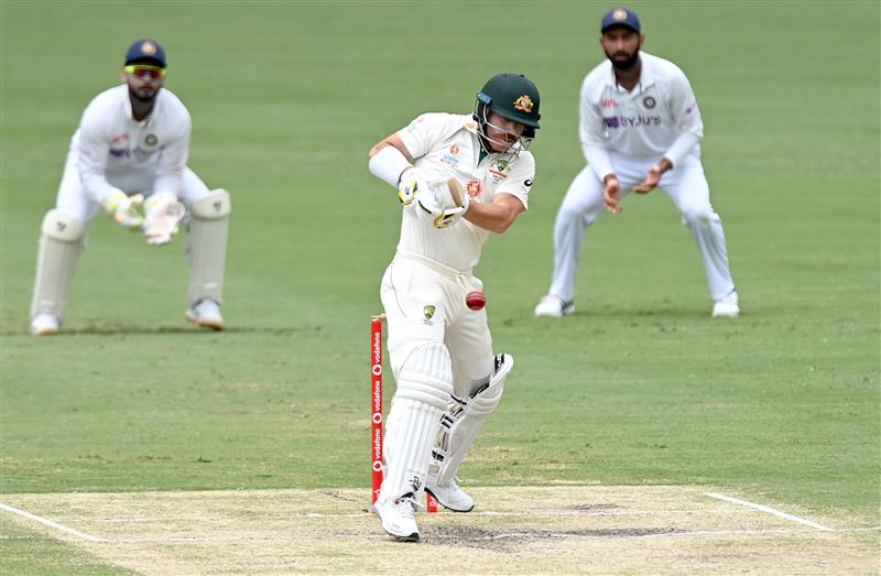 BRISBANE, AUSTRALIA - JANUARY 18: David Warner of Australia plays a shot during day four of the 4th Test Match in the series between Australia and India at The Gabba on January 18, 2021 in Brisbane, Australia. (Photo by Bradley Kanaris/Getty Images)