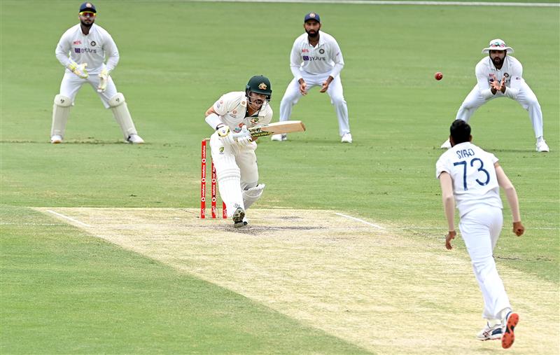 BRISBANE, AUSTRALIA - JANUARY 18: David Warner of Australia plays a shot during day four of the 4th Test Match in the series between Australia and India at The Gabba on January 18, 2021 in Brisbane, Australia. (Photo by Bradley Kanaris/Getty Images)