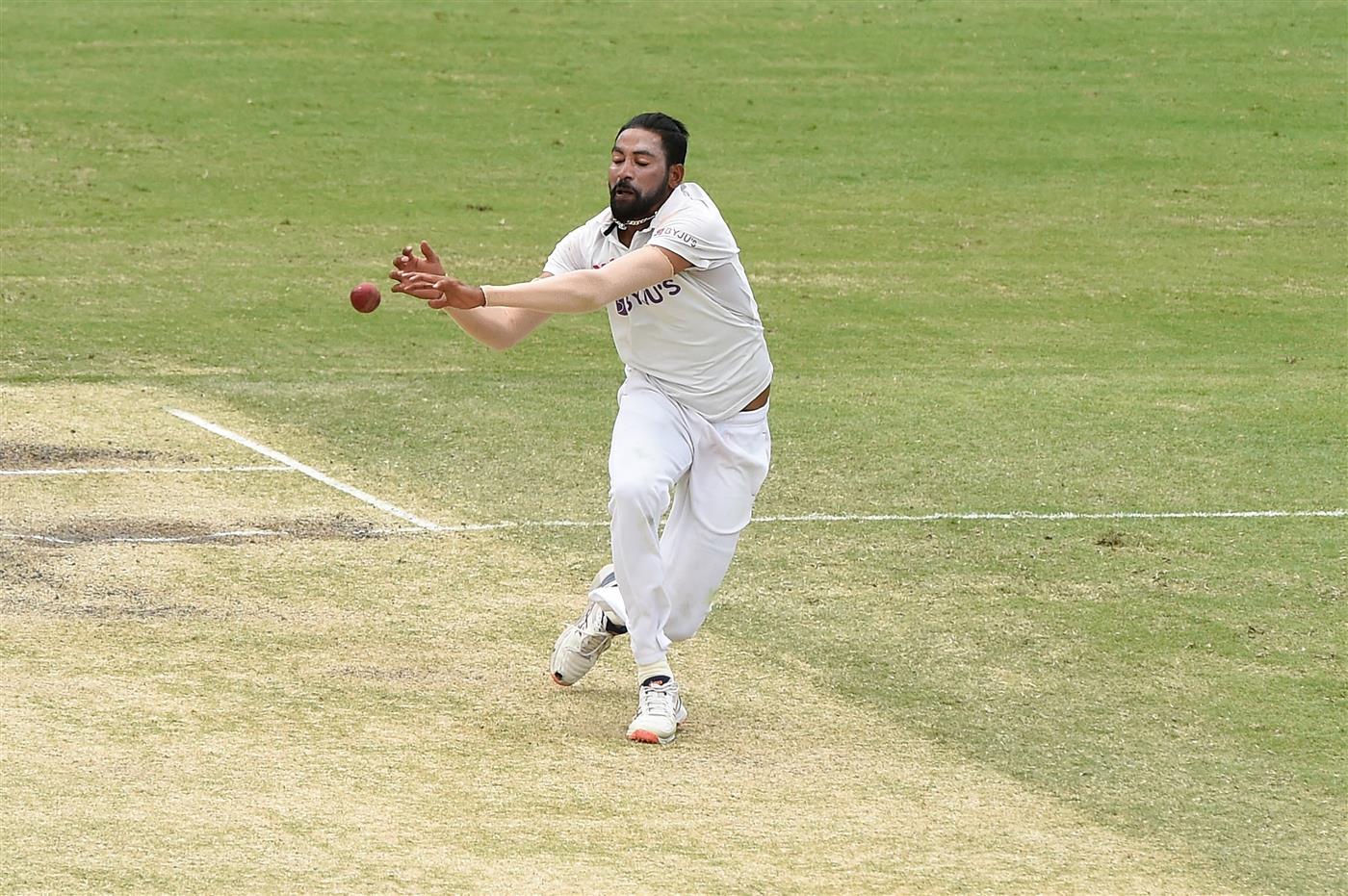 BRISBANE, AUSTRALIA - JANUARY 18: Mohammed Siraj of India fields off his own bowling during day four of the 4th Test Match in the series between Australia and India at The Gabba on January 18, 2021 in Brisbane, Australia. (Photo by Matt Roberts/Getty Images)