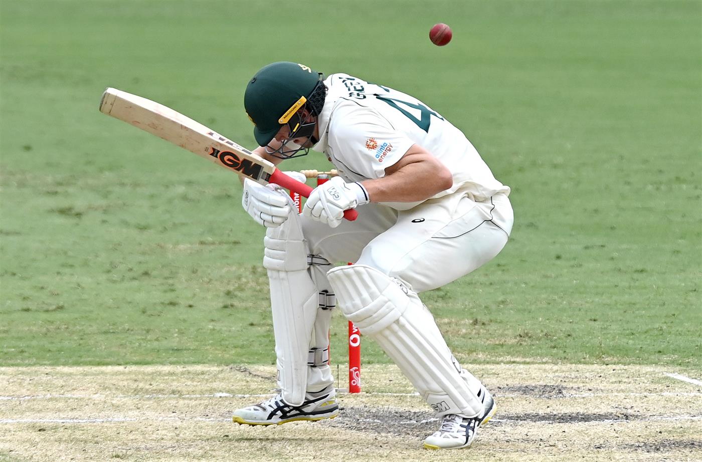 BRISBANE, AUSTRALIA - JANUARY 18: Cameron Green of Australia ducks a bouncer during day four of the 4th Test Match in the series between Australia and India at The Gabba on January 18, 2021 in Brisbane, Australia. (Photo by Bradley Kanaris/Getty Images)