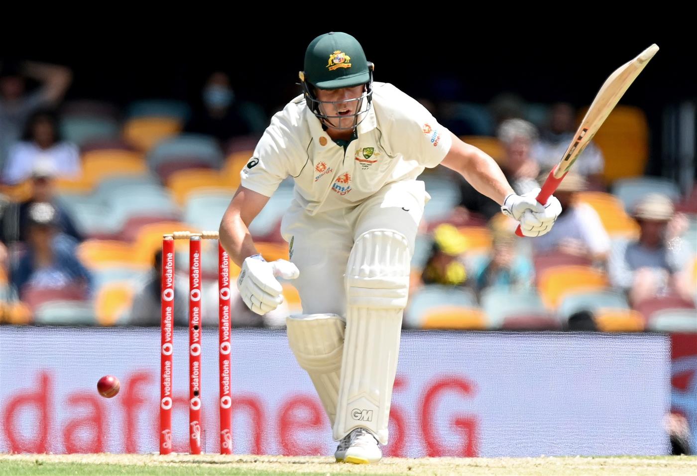BRISBANE, AUSTRALIA - JANUARY 18: Cameron Green of Australia reacts after being struck by the ball during day four of the 4th Test Match in the series between Australia and India at The Gabba on January 18, 2021 in Brisbane, Australia. (Photo by Bradley Kanaris/Getty Images)