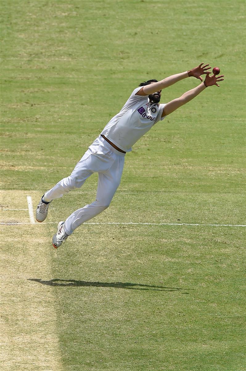 BRISBANE, AUSTRALIA - JANUARY 18: Mohammed Siraj of India fields off his own bowling during day four of the 4th Test Match in the series between Australia and India at The Gabba on January 18, 2021 in Brisbane, Australia. (Photo by Matt Roberts/Getty Images)