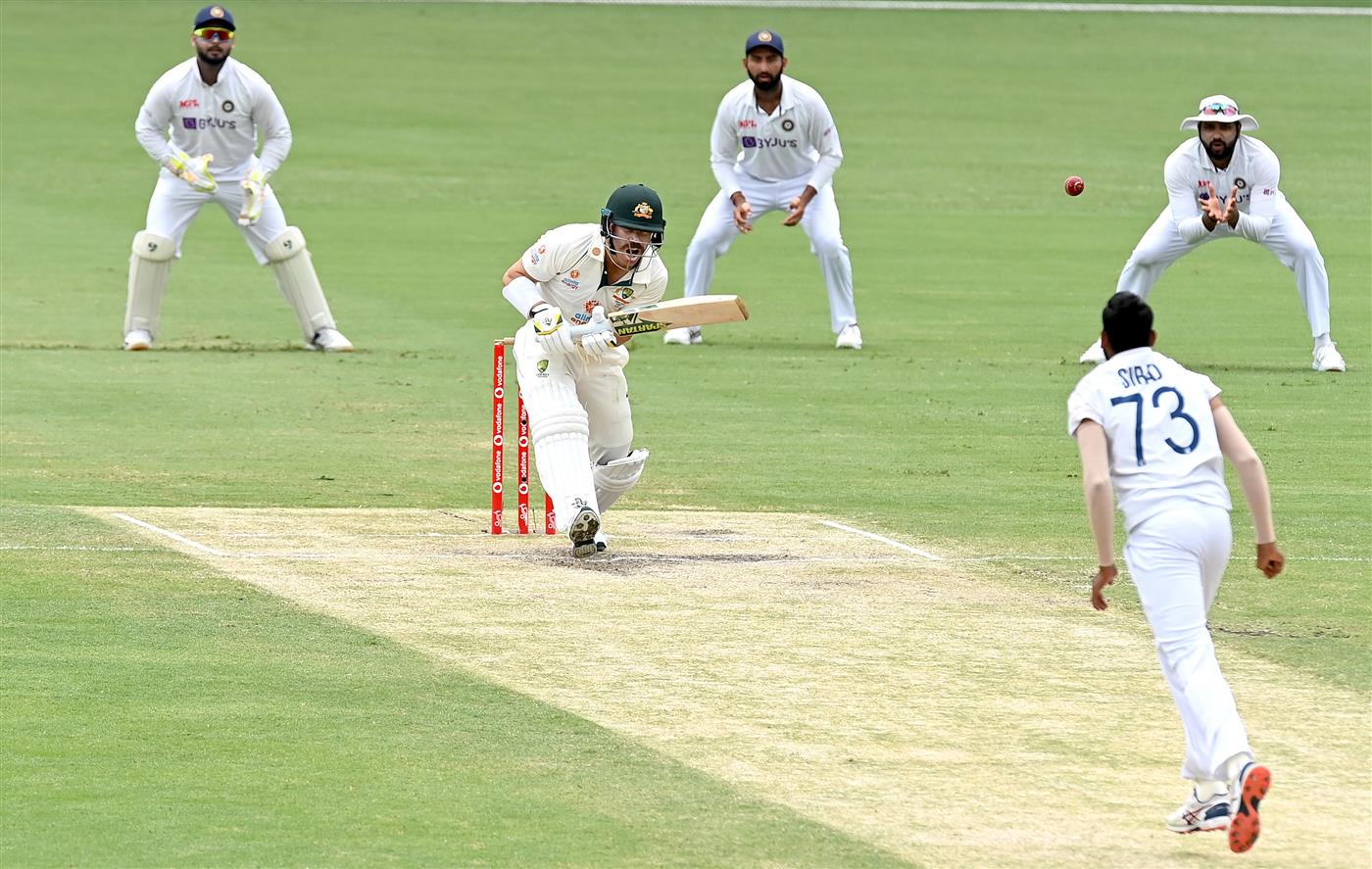 BRISBANE, AUSTRALIA - JANUARY 18: David Warner of Australia plays a shot during day four of the 4th Test Match in the series between Australia and India at The Gabba on January 18, 2021 in Brisbane, Australia. (Photo by Bradley Kanaris/Getty Images)