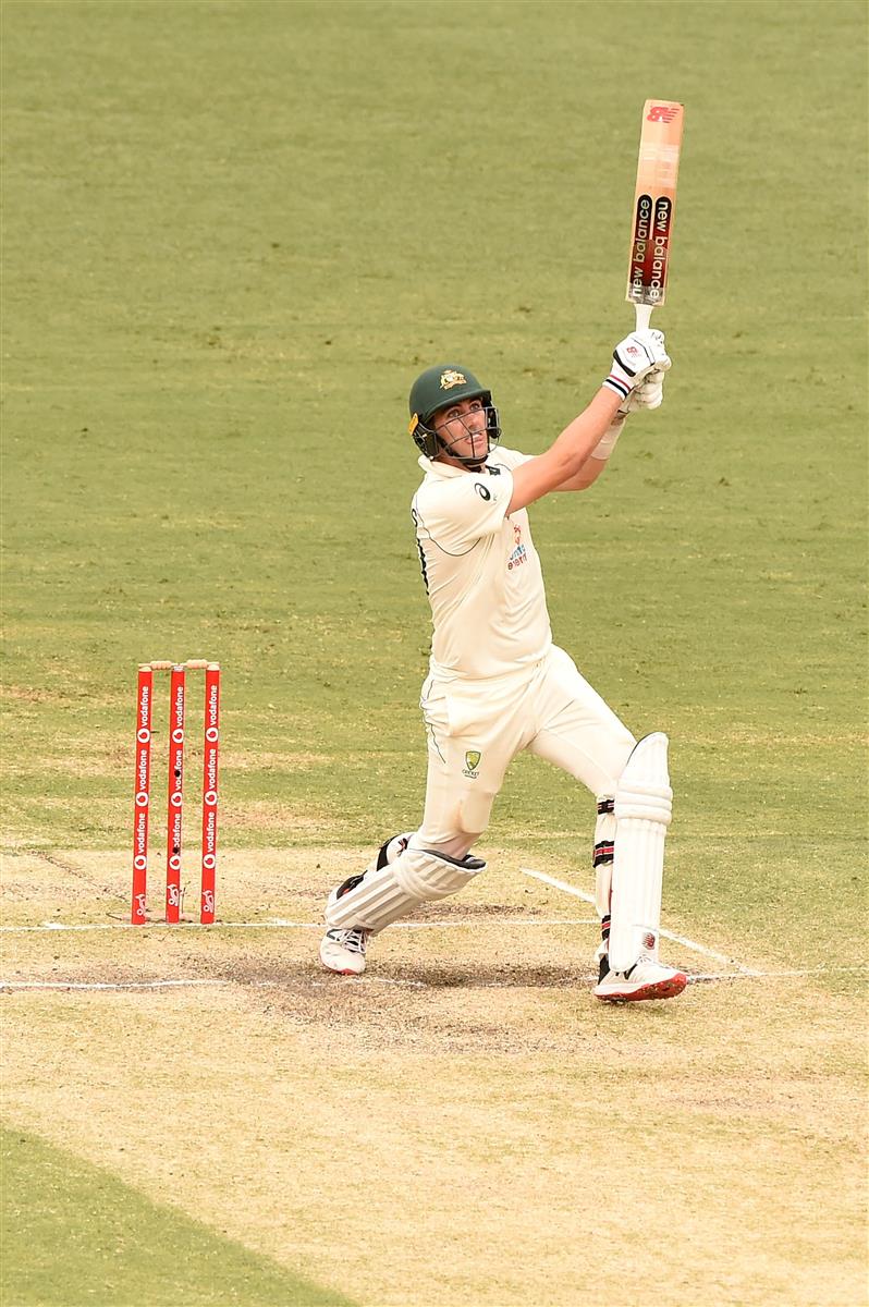 BRISBANE, AUSTRALIA - JANUARY 18: Pat Cummins of Australia 
bats during day four of the 4th Test Match in the series between Australia and India at The Gabba on January 18, 2021 in Brisbane, Australia. (Photo by Matt Roberts/Getty Images)