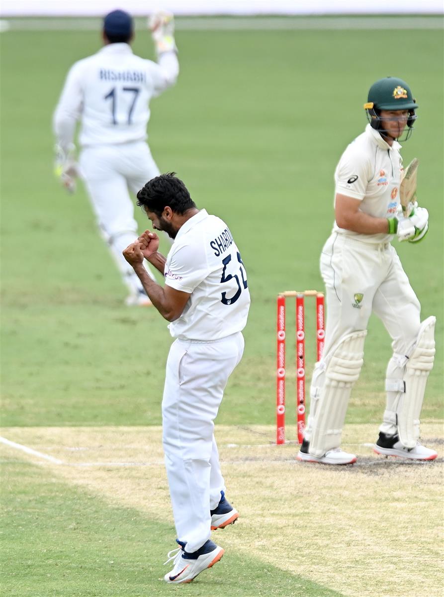 BRISBANE, AUSTRALIA - JANUARY 18: Shardul Thakur of India celebrates taking the wicket of Tim Paine of Australia during day four of the 4th Test Match in the series between Australia and India at The Gabba on January 18, 2021 in Brisbane, Australia. (Photo by Bradley Kanaris/Getty Images)