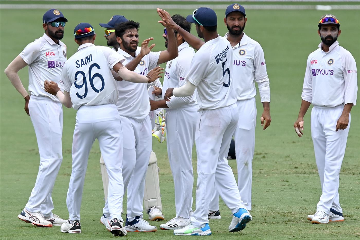 BRISBANE, AUSTRALIA - JANUARY 18: Shardul Thakur of India celebrates taking the wicket of Marcus Harris of Australia during day four of the 4th Test Match in the series between Australia and India at The Gabba on January 18, 2021 in Brisbane, Australia. (Photo by Bradley Kanaris/Getty Images)