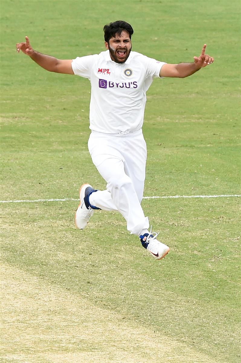 BRISBANE, AUSTRALIA - JANUARY 18: Shardul Thakur of India celebrates the wicket of Tim Paine of Australia during day four of the 4th Test Match in the series between Australia and India at The Gabba on January 18, 2021 in Brisbane, Australia. (Photo by Matt Roberts/Getty Images)