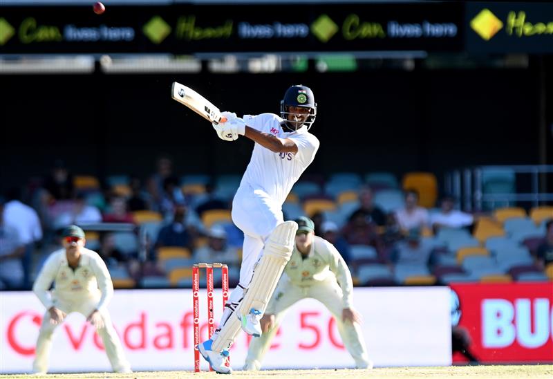 BRISBANE, AUSTRALIA - JANUARY 19: Washington Sundar of India hits the ball over the boundary for a six during day five of the 4th Test Match in the series between Australia and India at The Gabba on January 19, 2021 in Brisbane, Australia. (Photo by Bradley Kanaris/Getty Images)
