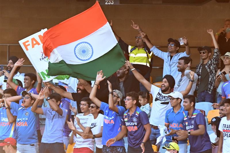 BRISBANE, AUSTRALIA - JANUARY 19: The Indian fans celebrate during day five of the 4th Test Match in the series between Australia and India at The Gabba on January 19, 2021 in Brisbane, Australia. (Photo by Bradley Kanaris/Getty Images)
