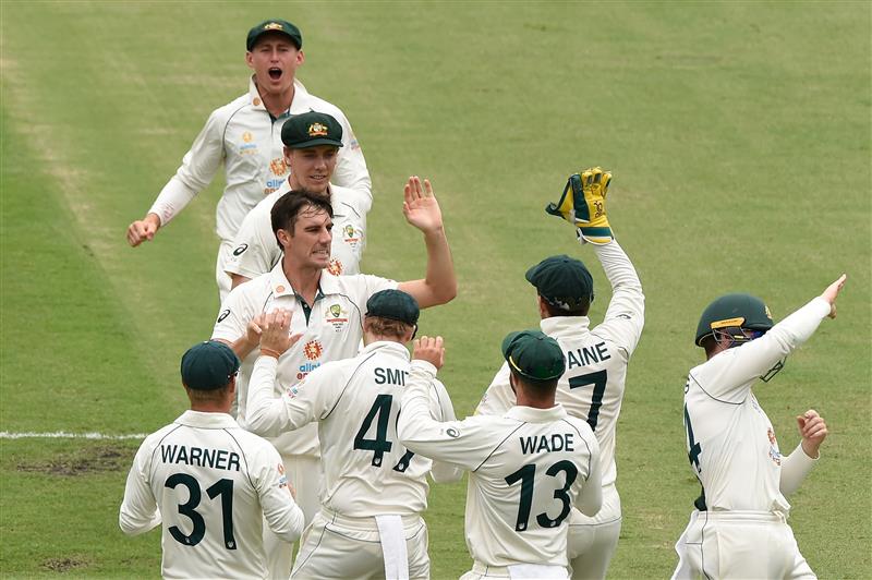 BRISBANE, AUSTRALIA - JANUARY 19: Pat Cummins of Australia  celebrates taking the wicket of Rohit Sharma of India during day five of the 4th Test Match in the series between Australia and India at The Gabba on January 19, 2021 in Brisbane, Australia. (Photo by Matt Roberts/Getty Images)