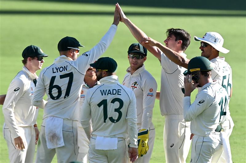 BRISBANE, AUSTRALIA - JANUARY 19: Pat Cummins of Australia celebrates taking the wicket of Mayank Agarwal of India during day five of the 4th Test Match in the series between Australia and India at The Gabba on January 19, 2021 in Brisbane, Australia. (Photo by Bradley Kanaris/Getty Images)