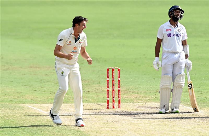 BRISBANE, AUSTRALIA - JANUARY 19: Pat Cummins of Australia and team mates celebrate taking the wicket of Cheteshwar Pujara during day five of the 4th Test Match in the series between Australia and India at The Gabba on January 19, 2021 in Brisbane, Australia. (Photo by Bradley Kanaris/Getty Images)