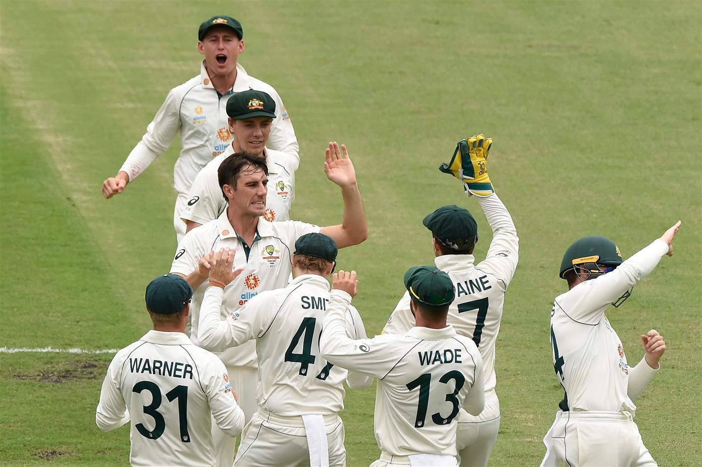 BRISBANE, AUSTRALIA - JANUARY 19: Pat Cummins of Australia  celebrates taking the wicket of Rohit Sharma of India during day five of the 4th Test Match in the series between Australia and India at The Gabba on January 19, 2021 in Brisbane, Australia. (Photo by Matt Roberts/Getty Images)