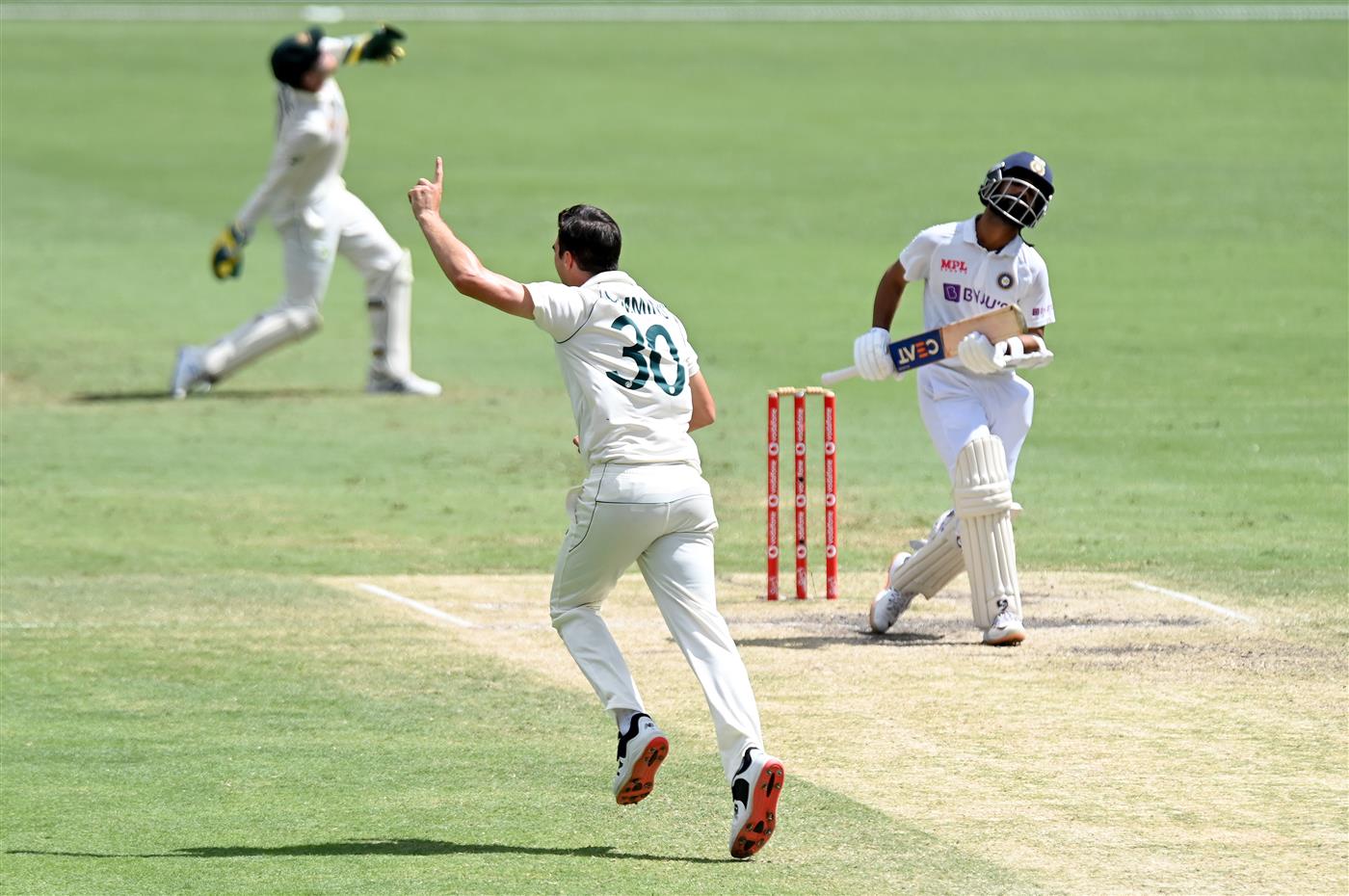 BRISBANE, AUSTRALIA - JANUARY 19: Pat Cummins of Australia celebrates taking the wicket of Ajinkya Rahane of India during day five of the 4th Test Match in the series between Australia and India at The Gabba on January 19, 2021 in Brisbane, Australia. (Photo by Bradley Kanaris/Getty Images)
