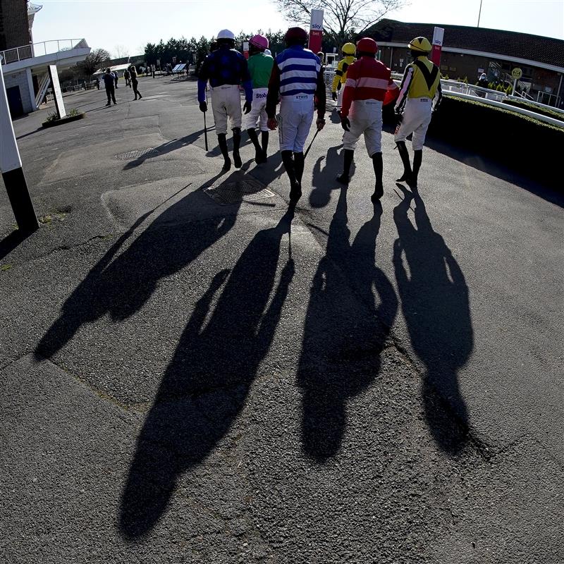 SUNBURY, ENGLAND - FEBRUARY 27: A general view as jockeys make their way to the parade ring on a sunny afternoon at Kempton Park Racecourse on February 27, 2021 in Sunbury, England. Due to the coronavirus pandemic, owners along with the paying public will not be allowed to attend the meeting. (Photo by Alan Crowhurst/Getty Images)