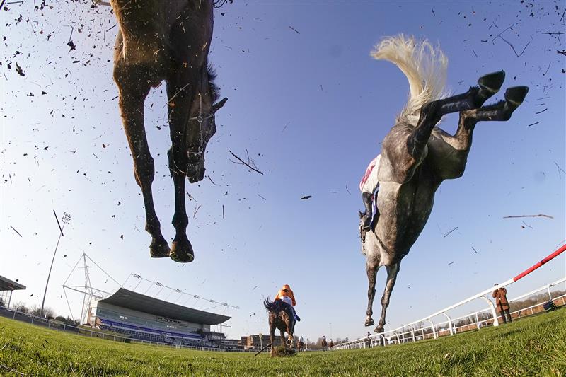 SUNBURY, ENGLAND - FEBRUARY 27: Action as runners clear a fence in the straight during The Close Brothers Handicap Chase at Kempton Park Racecourse on February 27, 2021 in Sunbury, England. Due to the coronavirus pandemic, owners along with the paying public will not be allowed to attend the meeting. (Photo by Alan Crowhurst/Getty Images)