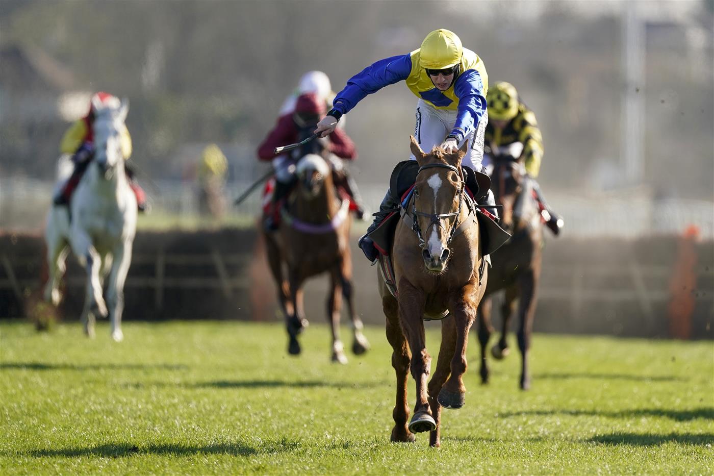 SUNBURY, ENGLAND - FEBRUARY 27: Ciaran Gethings riding Hometown Boy clear the last to win The Close Brothers Asset Finance Handicap Hurdle at Kempton Park Racecourse on February 27, 2021 in Sunbury, England. Due to the coronavirus pandemic, owners along with the paying public will not be allowed to attend the meeting. (Photo by Alan Crowhurst/Getty Images)