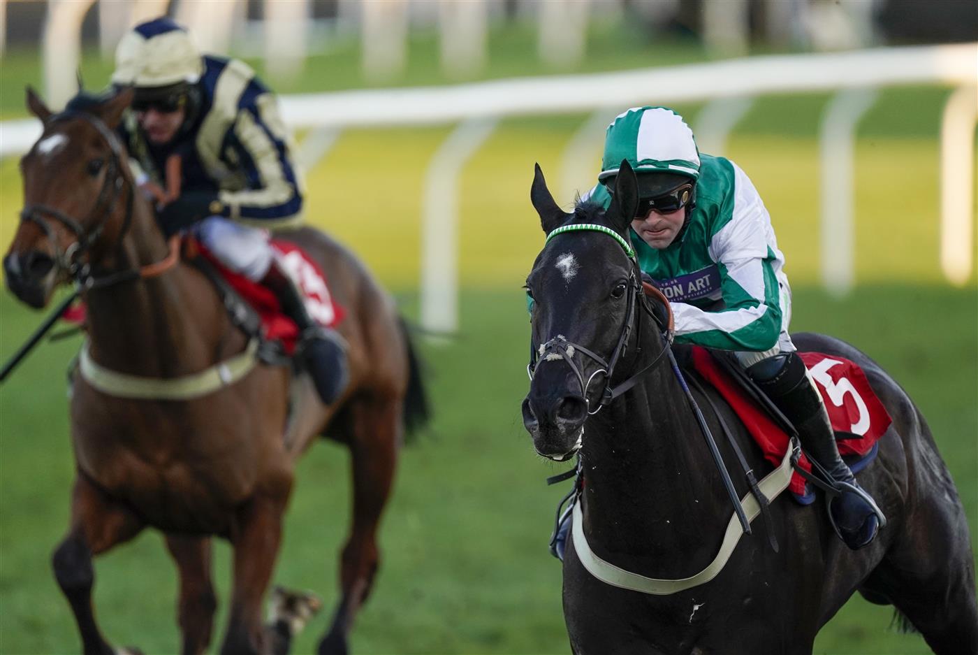 SUNBURY, ENGLAND - FEBRUARY 27: Nico de Boinville riding Guardino (green) win The Close Brothers Premium Finance Standard Open NH Flat Race at Kempton Park Racecourse on February 27, 2021 in Sunbury, England. Due to the coronavirus pandemic, owners along with the paying public will not be allowed to attend the meeting. (Photo by Alan Crowhurst/Getty Images)