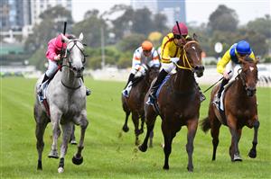 MELBOURNE, AUSTRALIA - FEBRUARY 27: Michael Poy riding Fabergino (grey) winning race 5, the Ata/bob Hoysted Handicap, during Melbourne Racing at Flemington Racecourse on February 27, 2021 in Melbourne, Australia. (Photo by Vince Caligiuri/Getty Images)