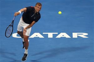 DOHA, QATAR - MARCH 10: Dan Evans of Great Britain serves in his match against Roger Federer of Switzerland on Day 3 of the Qatar ExxonMobil Open at Khalifa International Tennis and Squash Complex on March 10, 2021 in Doha, Qatar. (Photo by Mohamed Farag/Getty Images)
