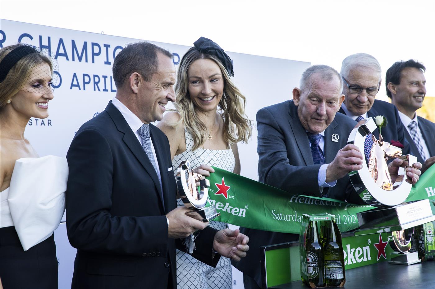 SYDNEY, AUSTRALIA - APRIL 10: Trainer Chris Waller and wife Stephanie Waller (C) are seen with connections at a trophy presentation after winning the Heineken T J Smith Stakes with Nature Strip during the Championships Day 1 at Royal Randwick Racecourse on April 10, 2021 in Sydney, Australia. A COVID-restricted crowd of 15,000 is expected to attend Day 1 of The Championships, the highlight of the Sydney Autumn Racing Carnival. The 2020 event was restricted to participants and essential staff only in the height of the coronavirus pandemic. The Championships Day 1 featuring four Group 1 events headlined by the $3 million Doncaster Mile and $2 million Australian Derby. (Photo by Jenny Evans/Getty Images)