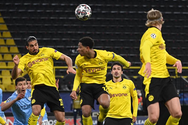 Players including Dortmund's German midfielder Emre Can, Dortmund's English midfielder Jude Bellingham and Dortmund's Norwegian forward Erling Braut Haaland jump tp head the ball during a corner kick during the UEFA Champions League quarter-final second leg football match between BVB Borussia Dortmund and Manchester City in Dortmund, western Germany, on April 14, 2021. (Photo by Ina Fassbender / various sources / AFP) (Photo by INA FASSBENDER/AFP via Getty Images)