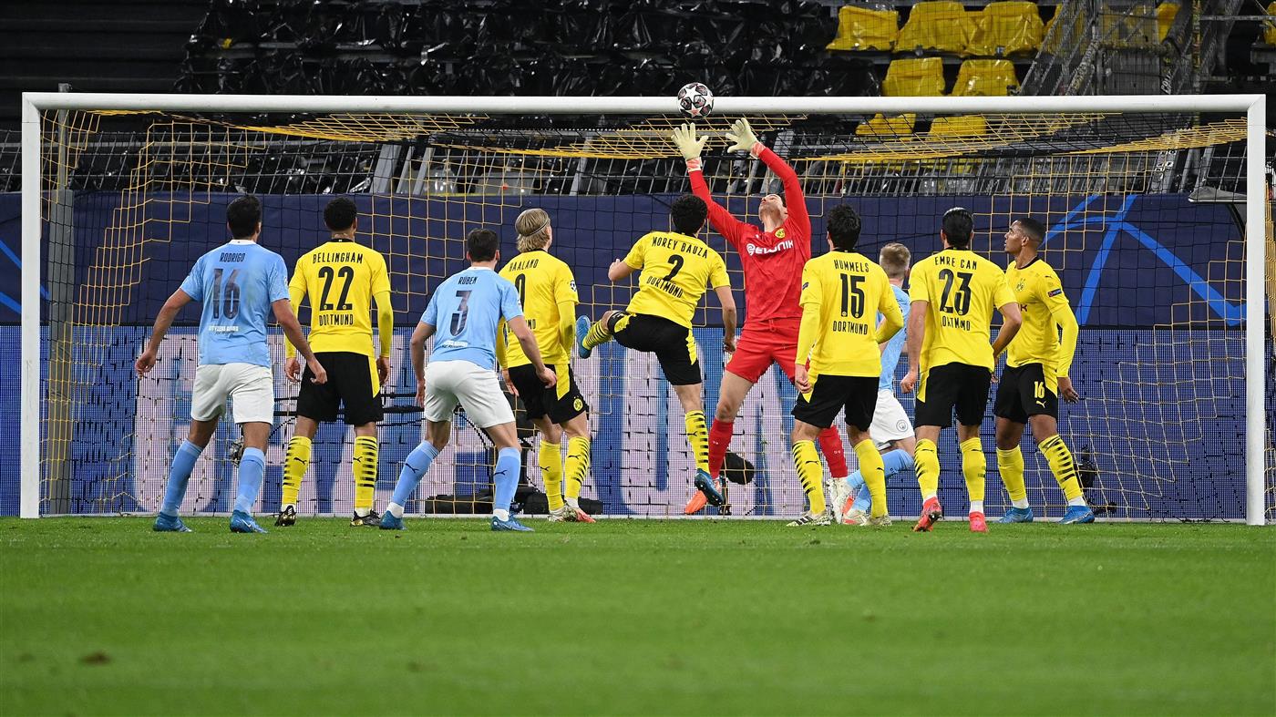 Dortmund's Swiss goalkeeper Marwin Hitz (C) makes a save during the UEFA Champions League quarter-final second leg football match between BVB Borussia Dortmund and Manchester City in Dortmund, western Germany, on April 14, 2021. (Photo by Ina Fassbender / various sources / AFP) (Photo by INA FASSBENDER/AFP via Getty Images)