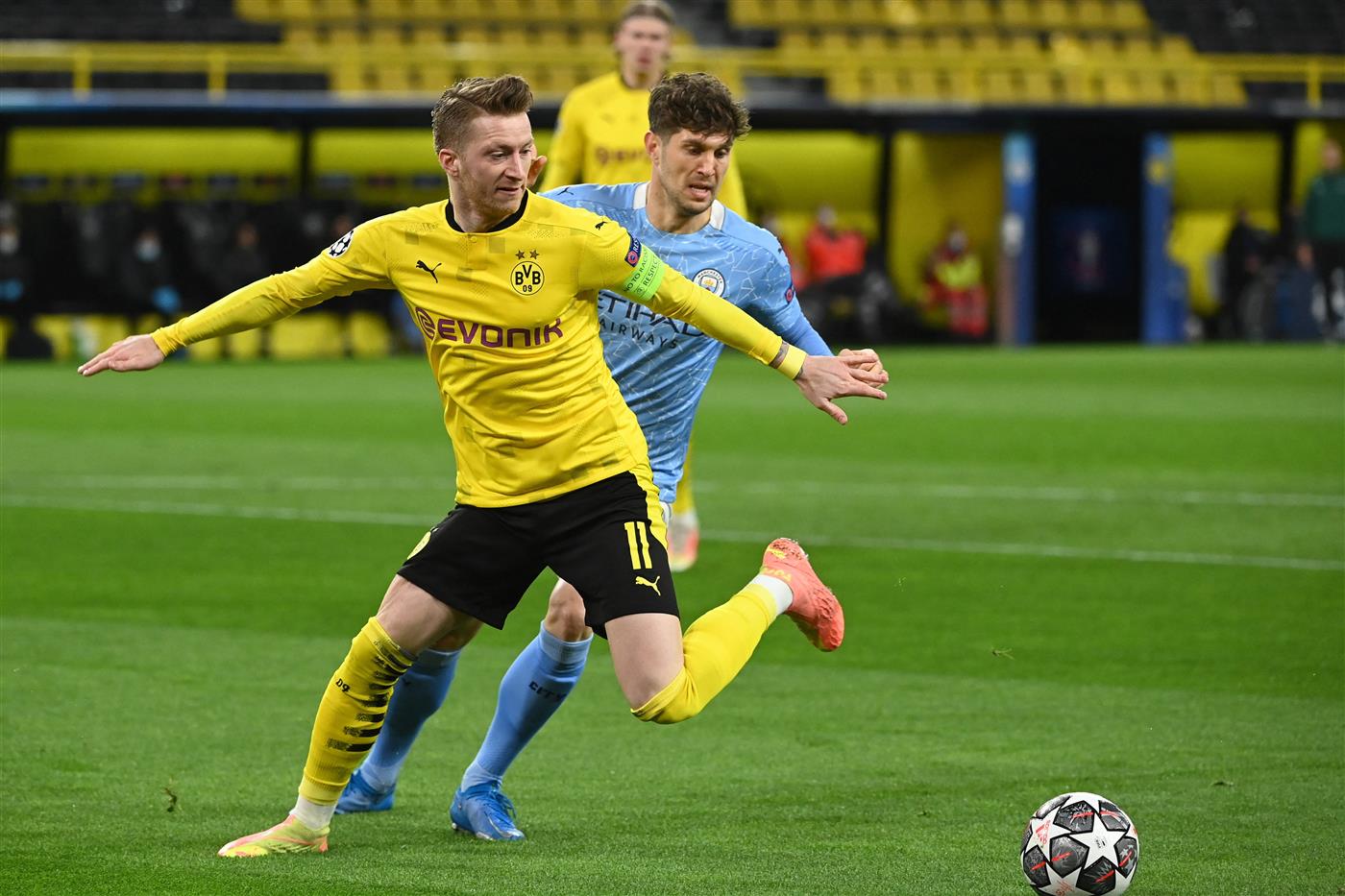 Dortmund's German forward Marco Reus (L) mand Manchester City's English defender John Stones vie for the ball during the UEFA Champions League quarter-final second leg football match between BVB Borussia Dortmund and Manchester City in Dortmund, western Germany, on April 14, 2021. (Photo by Ina Fassbender / various sources / AFP) (Photo by INA FASSBENDER/AFP via Getty Images)