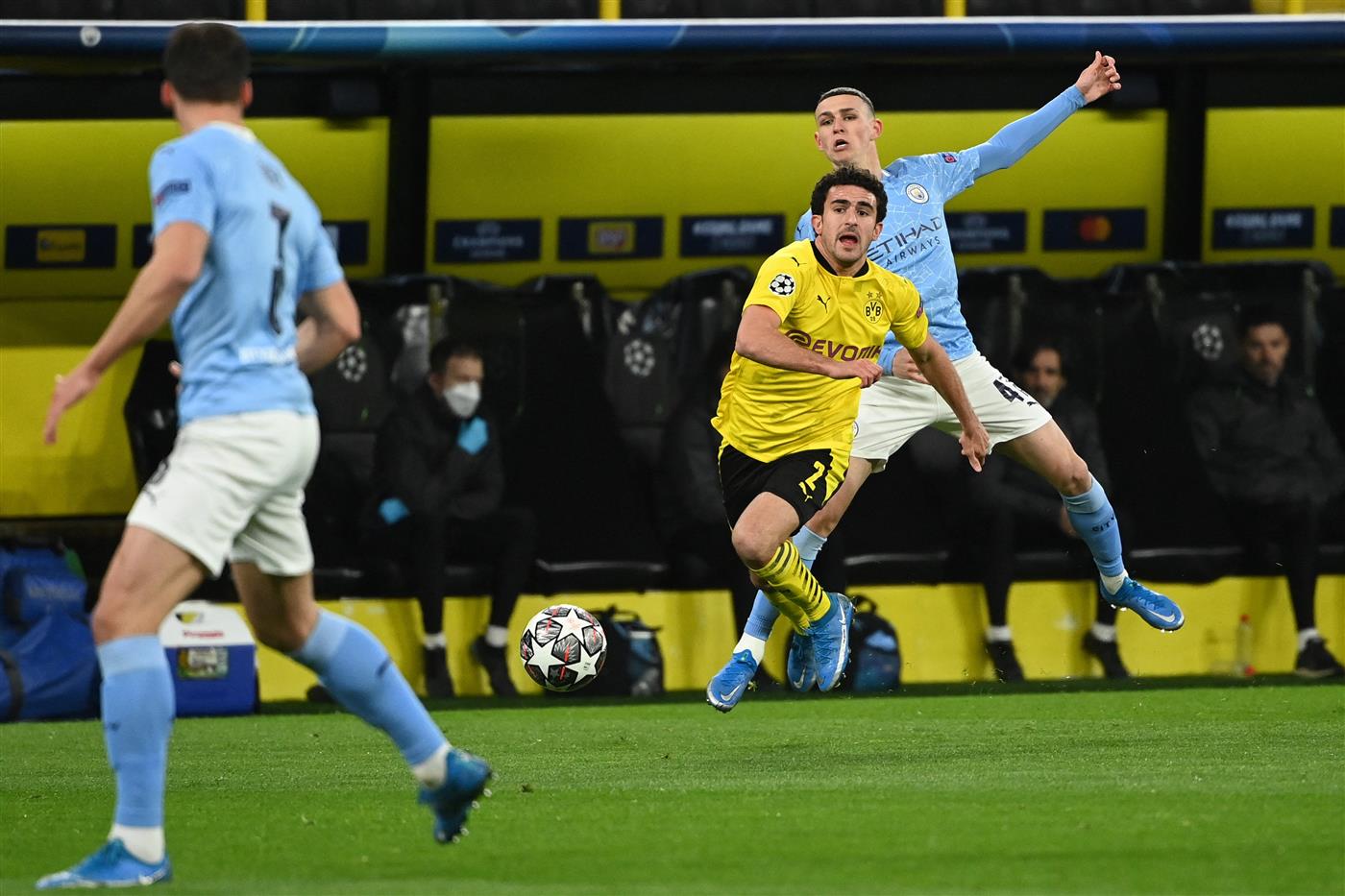 Manchester City's English midfielder Phil Foden (R) and Dortmund's Spanish defender Mateu Morey (C) vie for the ball during the UEFA Champions League quarter-final second leg football match between BVB Borussia Dortmund and Manchester City in Dortmund, western Germany, on April 14, 2021. (Photo by Ina Fassbender / various sources / AFP) (Photo by INA FASSBENDER/AFP via Getty Images)